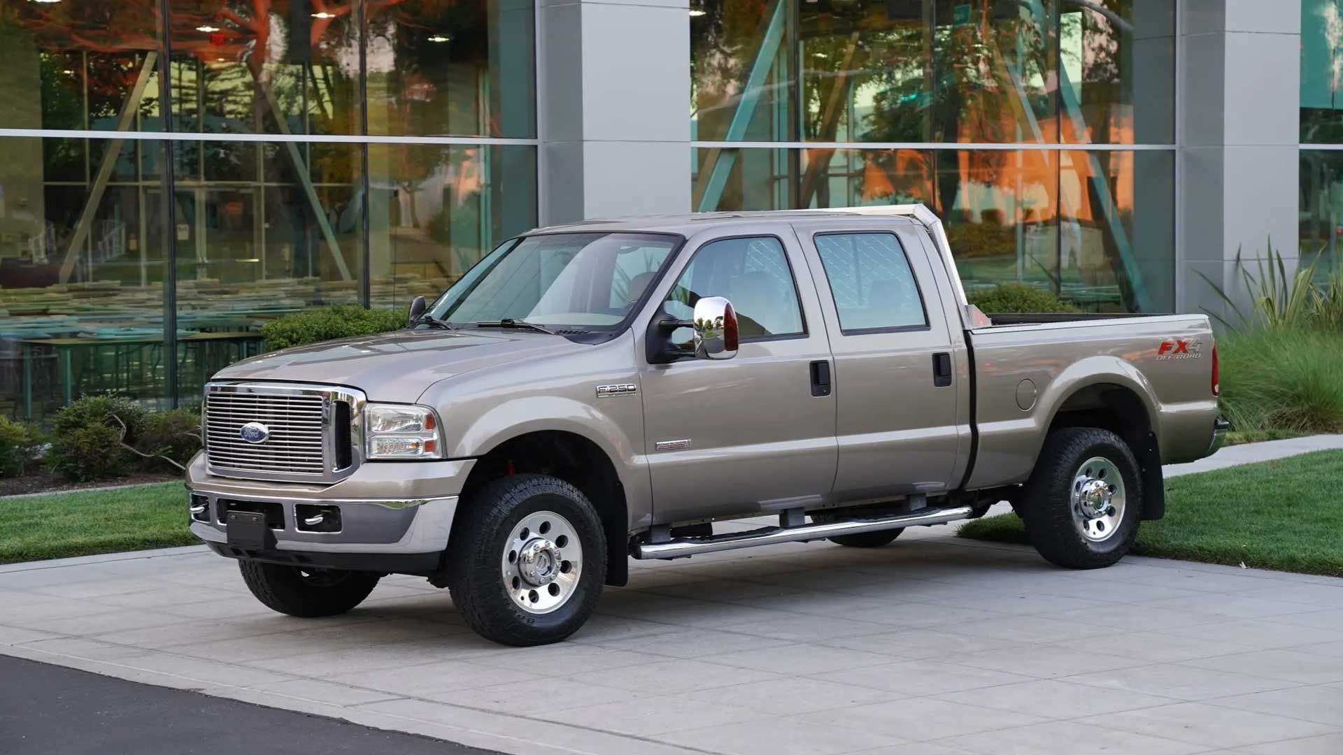 silver ford f-250 crew cab parked near modern building