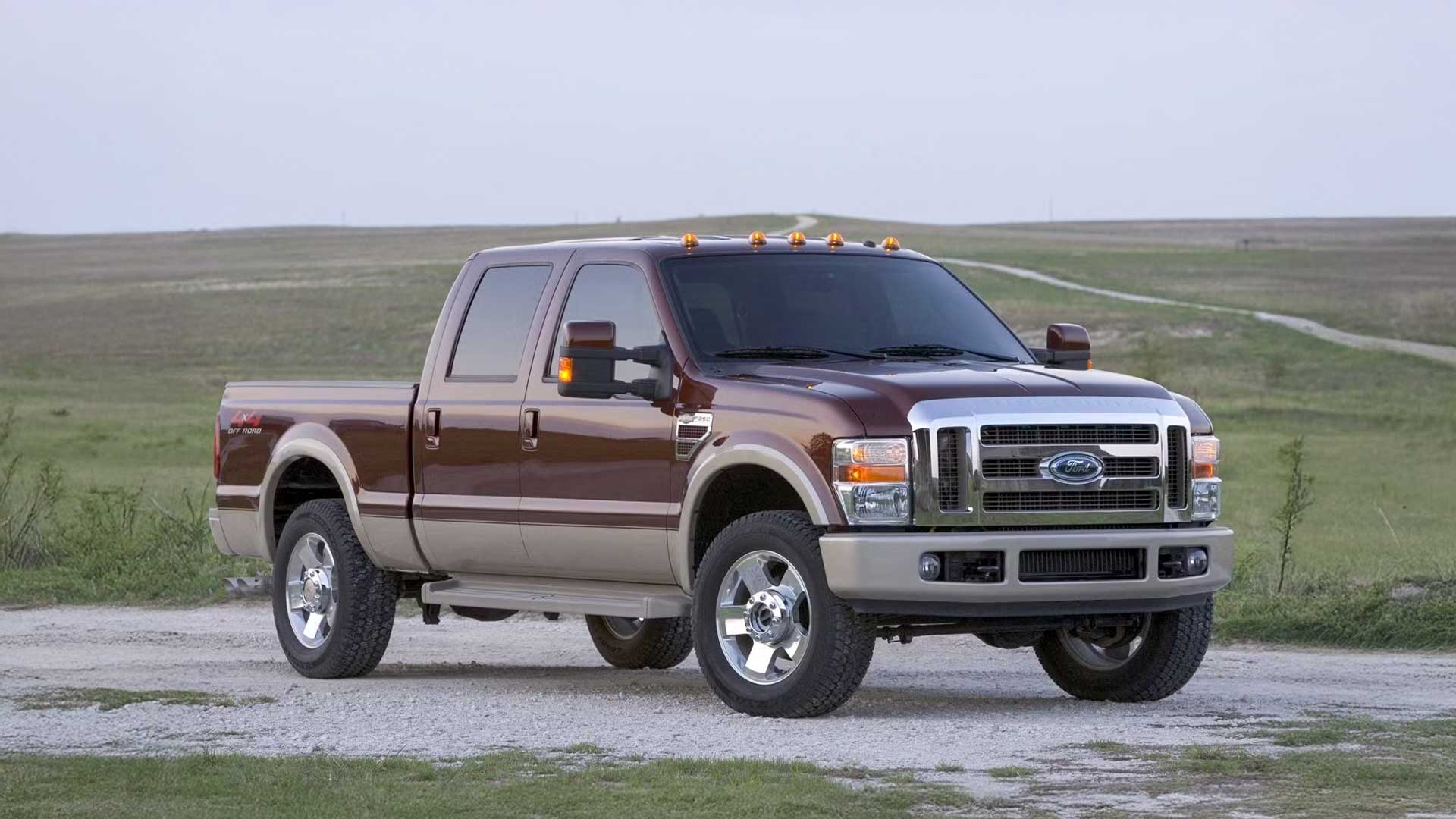 two-tone brown ford f-250 crew cab on dirt road