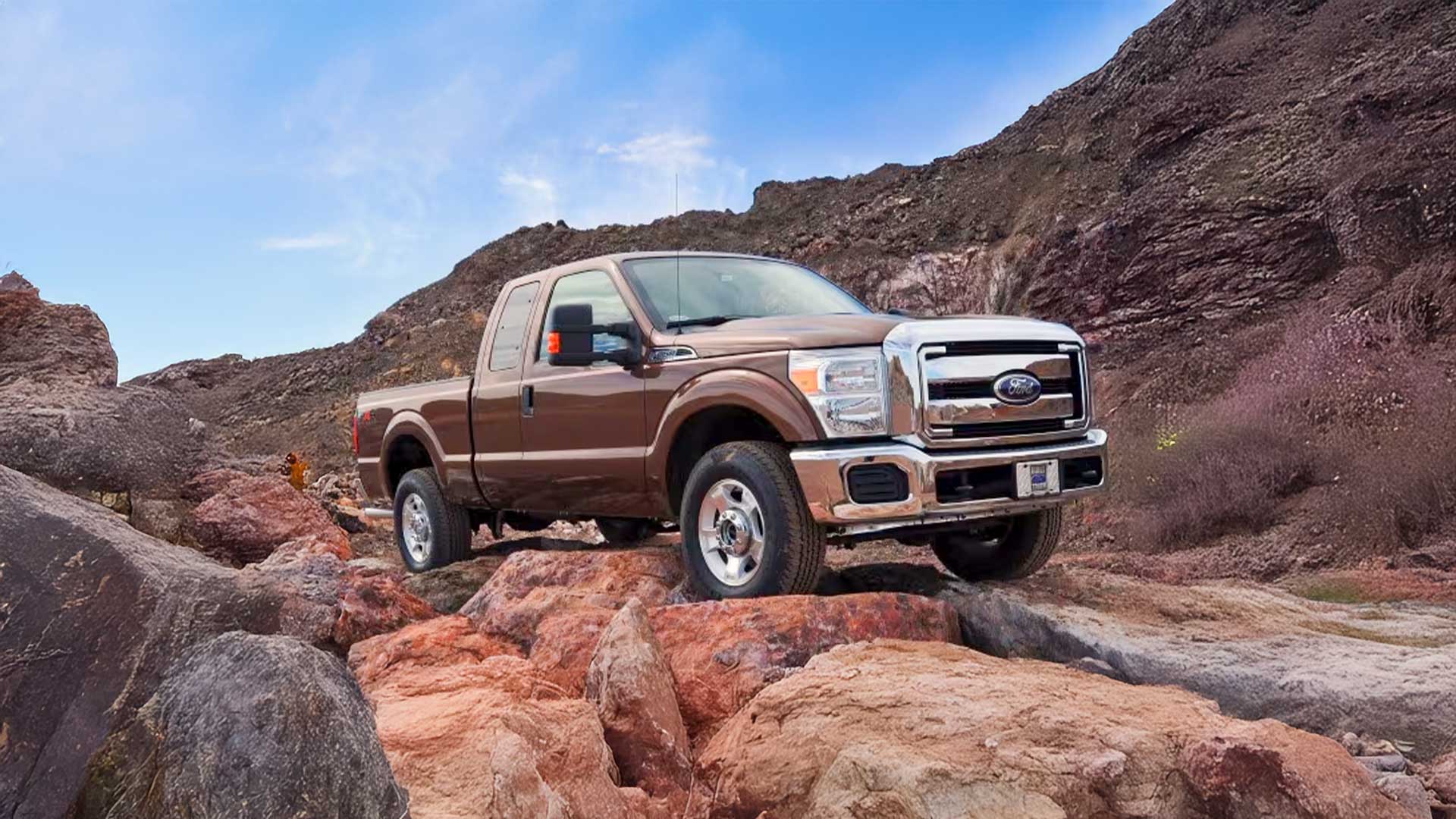 brown ford f-250 truck on rocky terrain