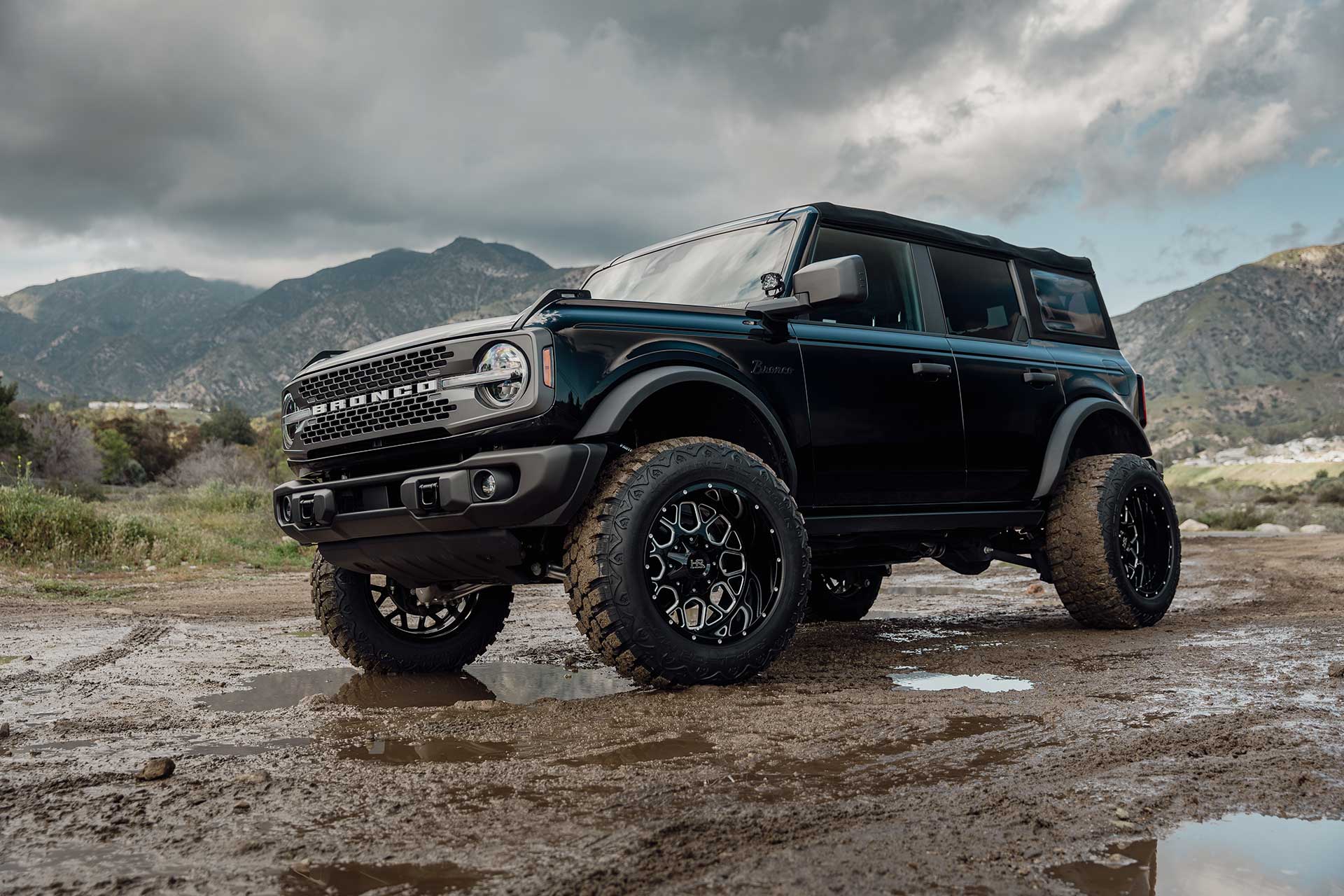 A sixth generation Ford Bronco with Repulsor M/T RX tires in the mud