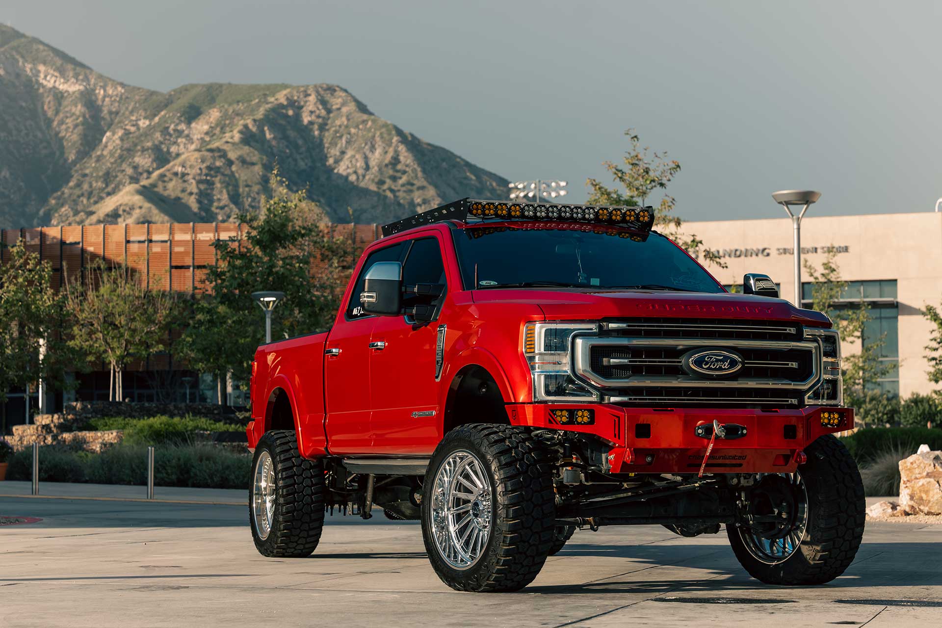 A red Ford F-350 Super Duty with RBP Repulsor M/T RX off-road tires