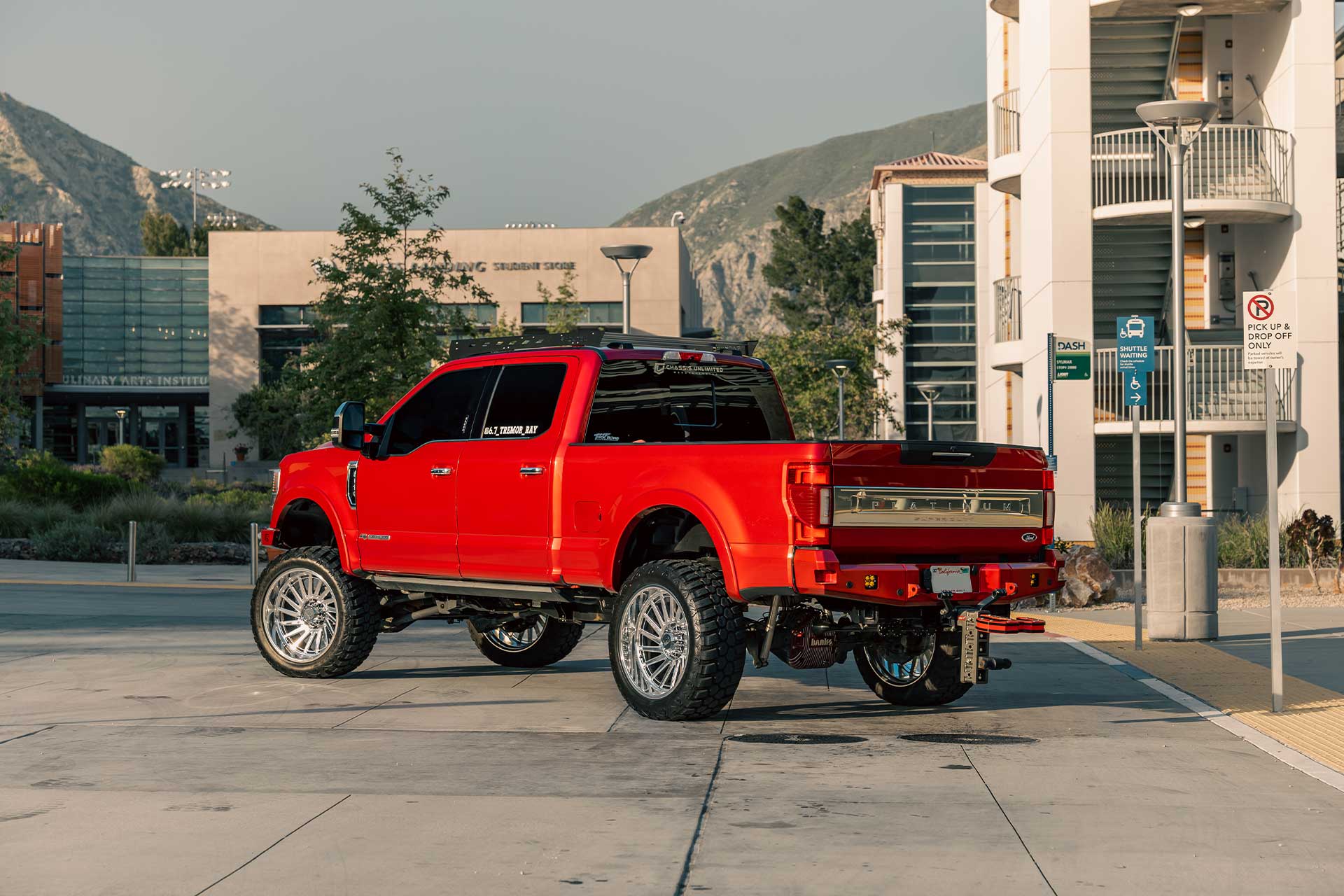 A red Ford F-350 Super Duty with RBP Repulsor M/T RX off-road tires