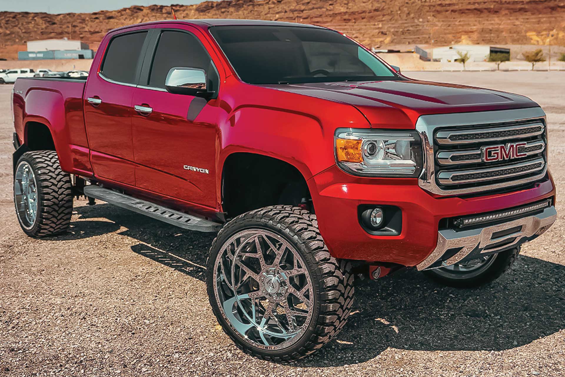 An image of a red GMC Canyon on RBP Repulsor M/T tires
