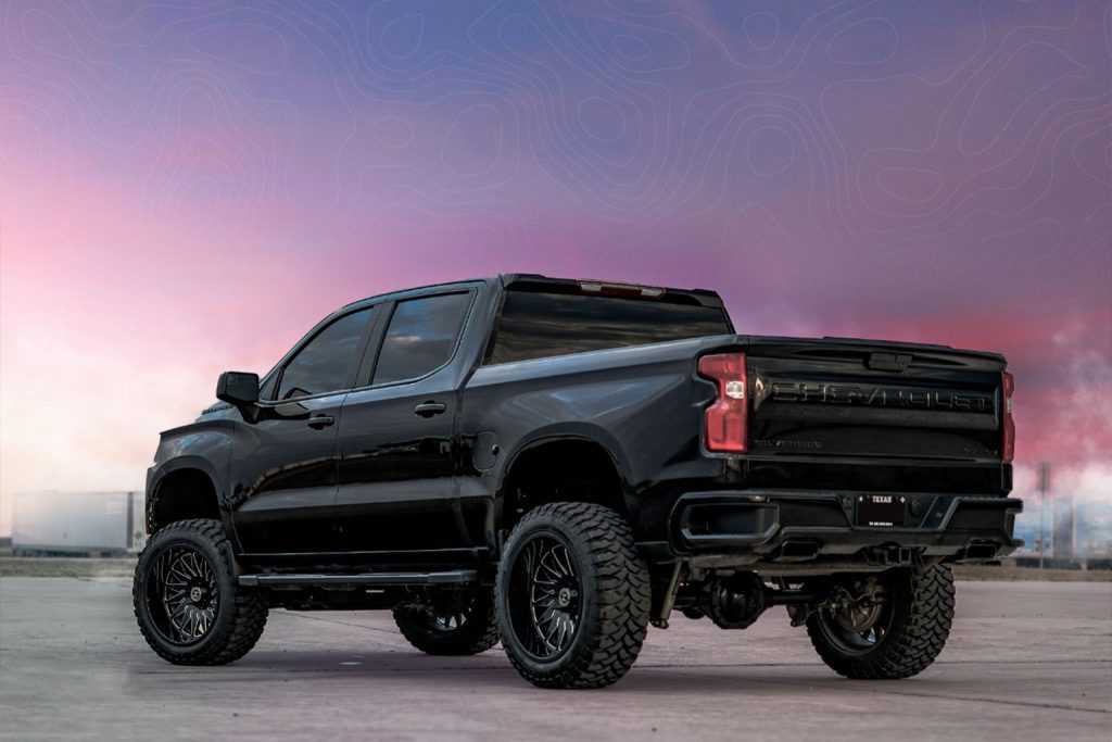Image of a black Chevy Silverado with RBP tires during sunset