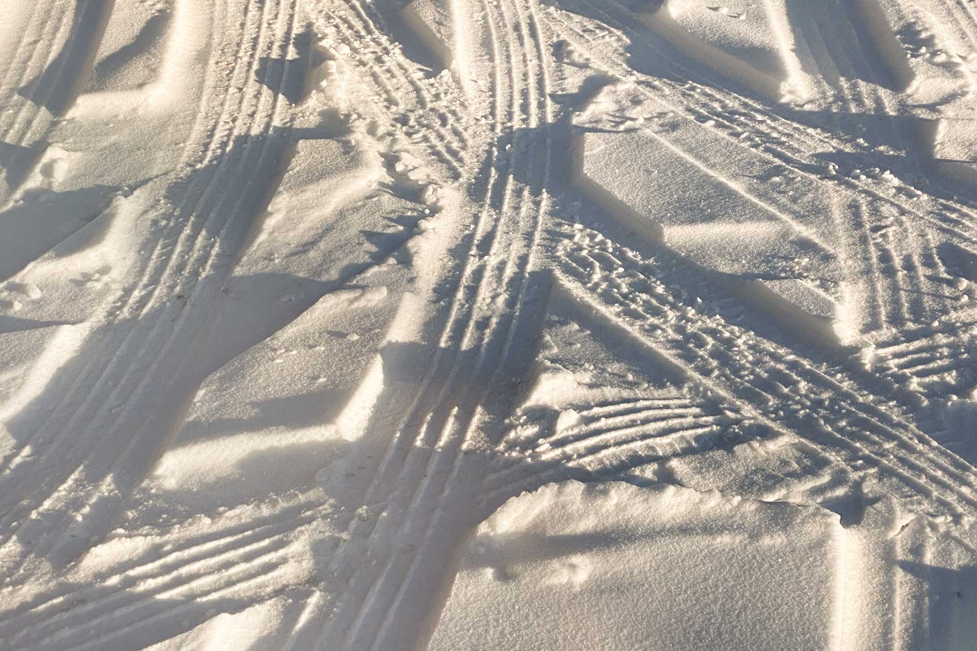 Powder snow with tire tracks on it