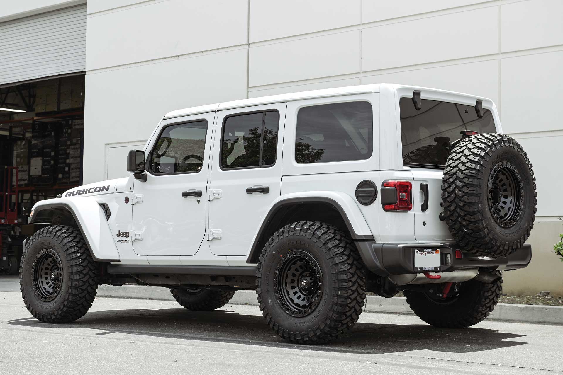 An image of a white Jeep Wrangler Rubicon on RBP Repulsor M/T tires