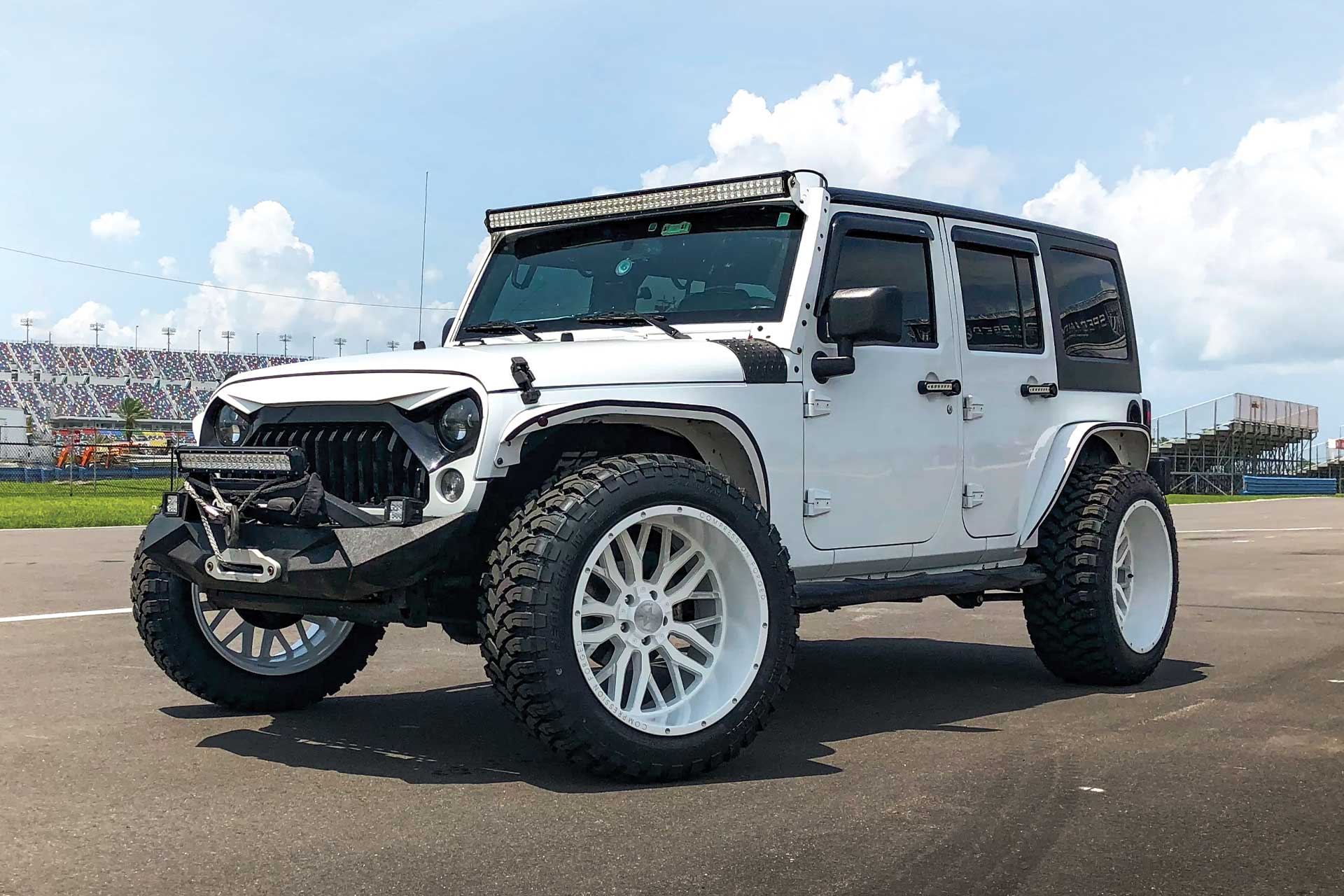 An image of a white Jeep Wrangler on RBP Repulsor M/T tires