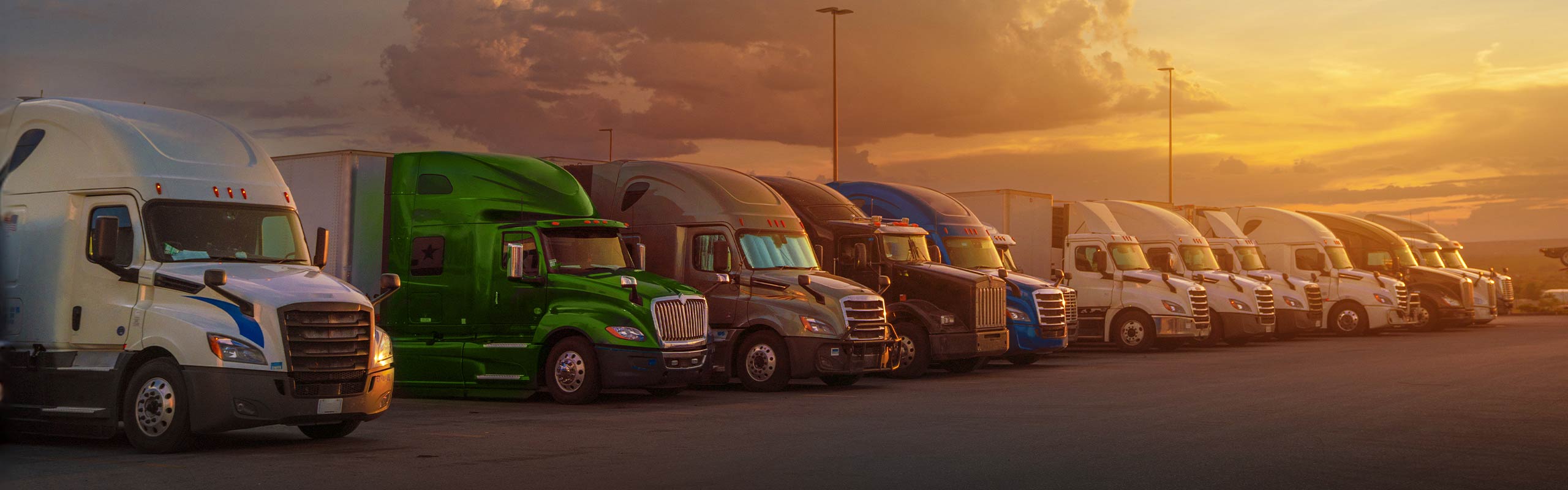 fleet of semi trucks during sunset