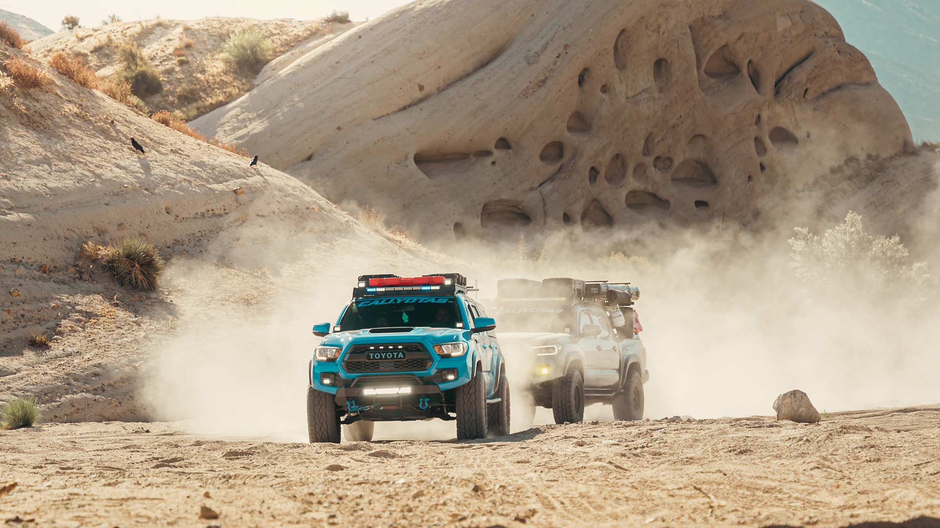 two toyota tacomas off roading at mormon rocks california